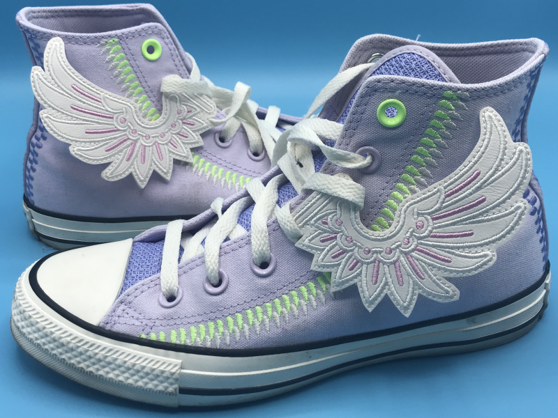Highly stylized embroidered wings, in the laces of hightop shoes