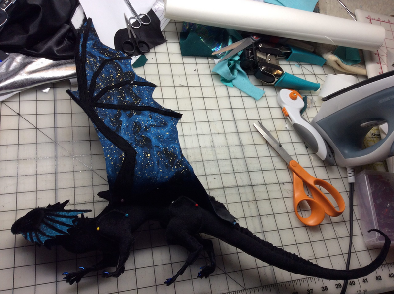 A five-year-old worktable picure of a dragon in progress, made from black velvet.