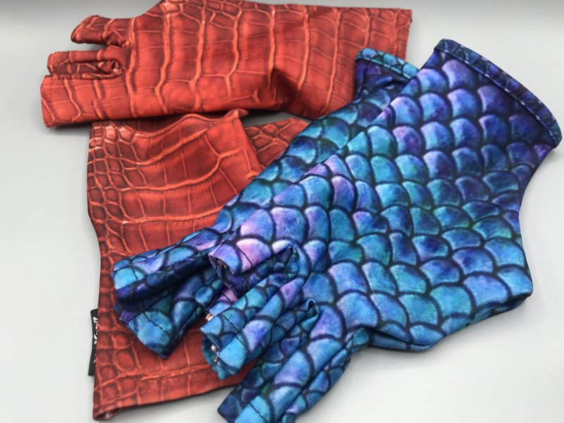 Compression gloves in red croc and blue-green mermaid scale prints.