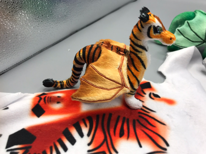 A normally-colored tiger dragon, on top of the fabric for a blazing orange one.