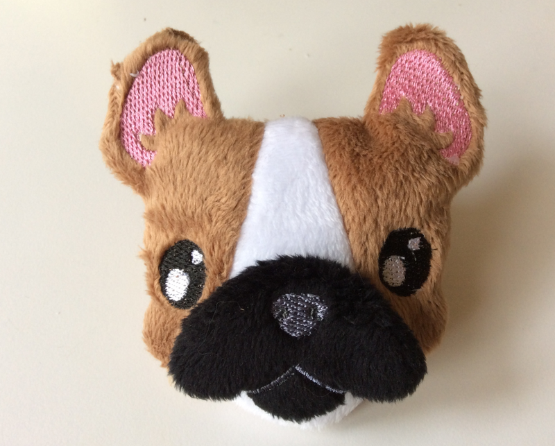 A plush Frenchie face