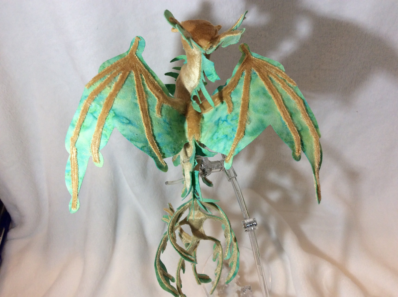 The wings of a velvet dragon with crests and frills that look like seaweed