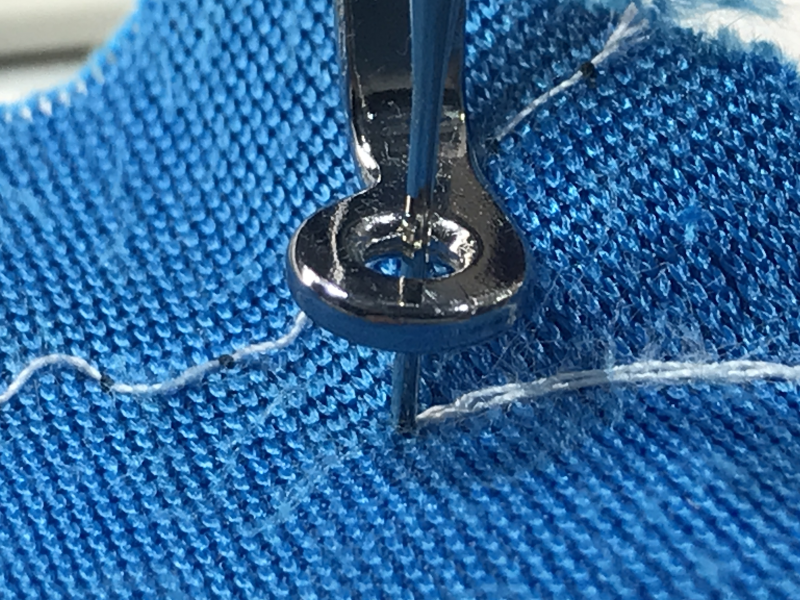 Closeup of the embroidery needle down in the fabric.