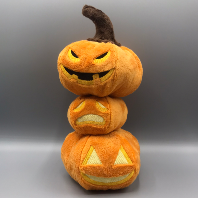 A stack of three plush pumpkins