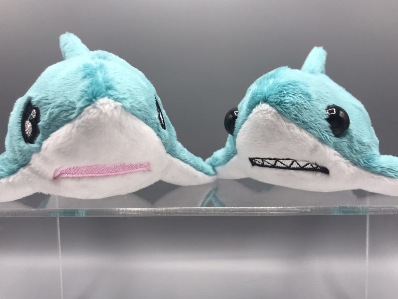 Two anxious-looking plush blue sharks.