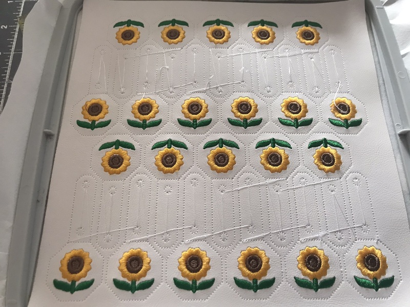An uncut sheet of sunflower snap tabs