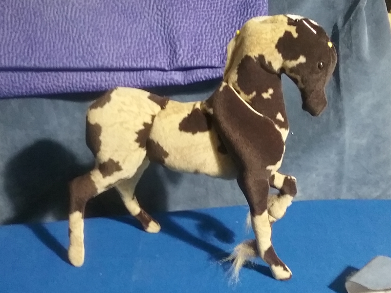 A five-year-old worktable picure of a unicorn in progress, made from cow-print velvet.