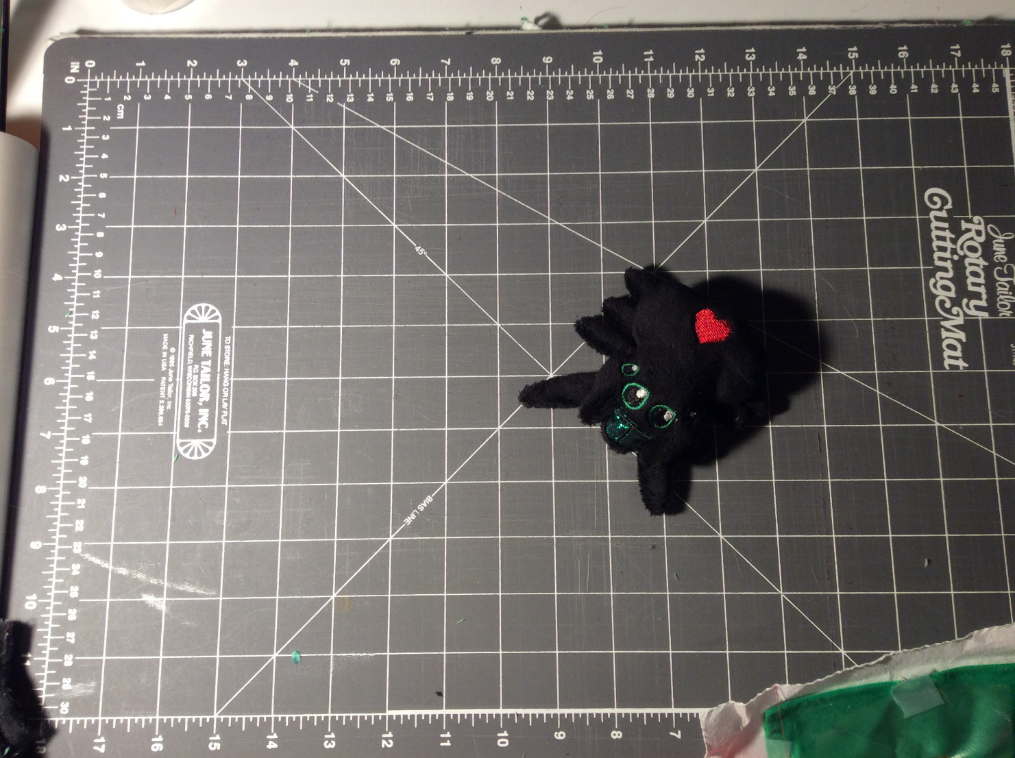 Plush jumping spider on cutting mat