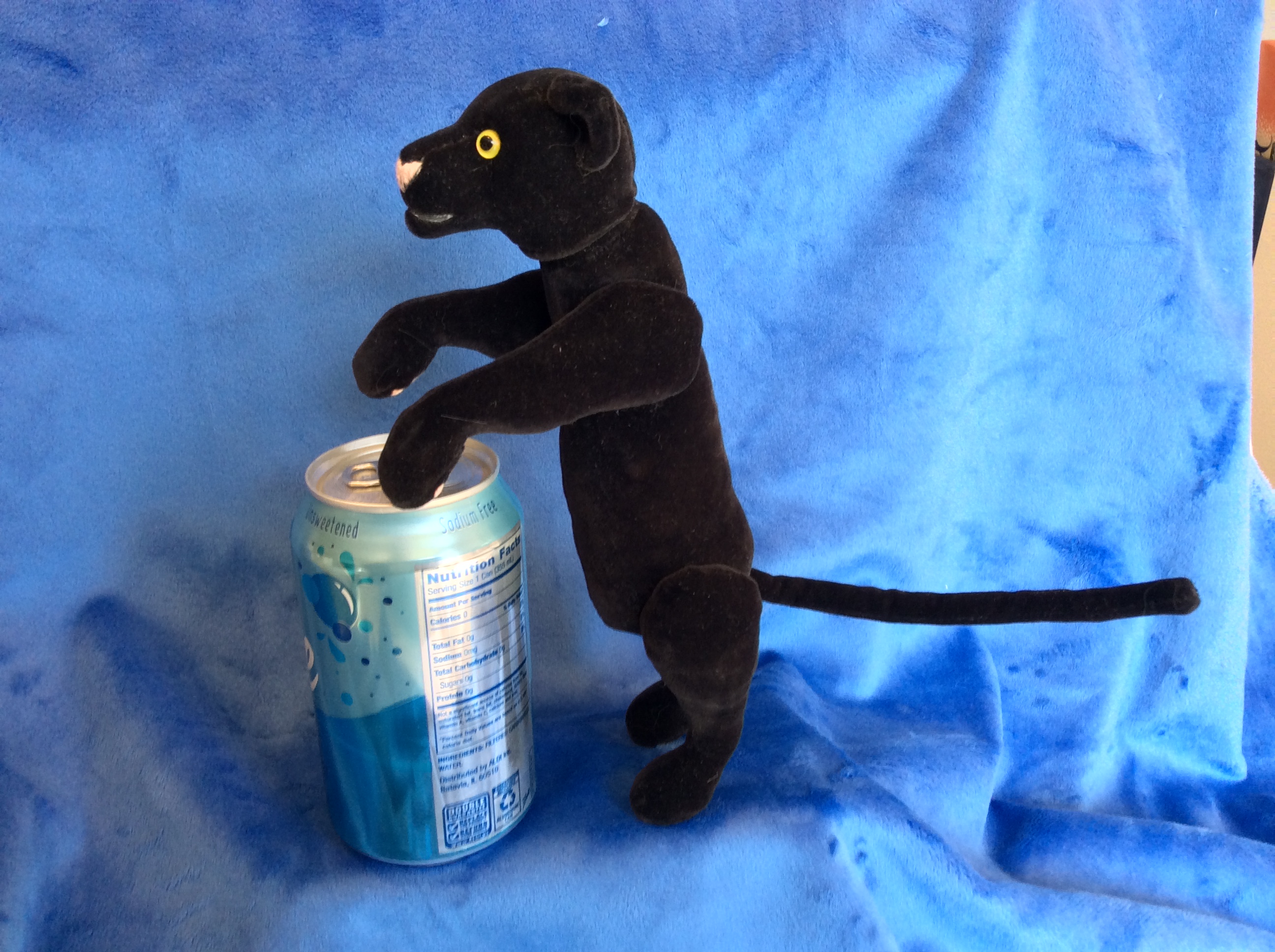 Black panther plush with seltzer for scale