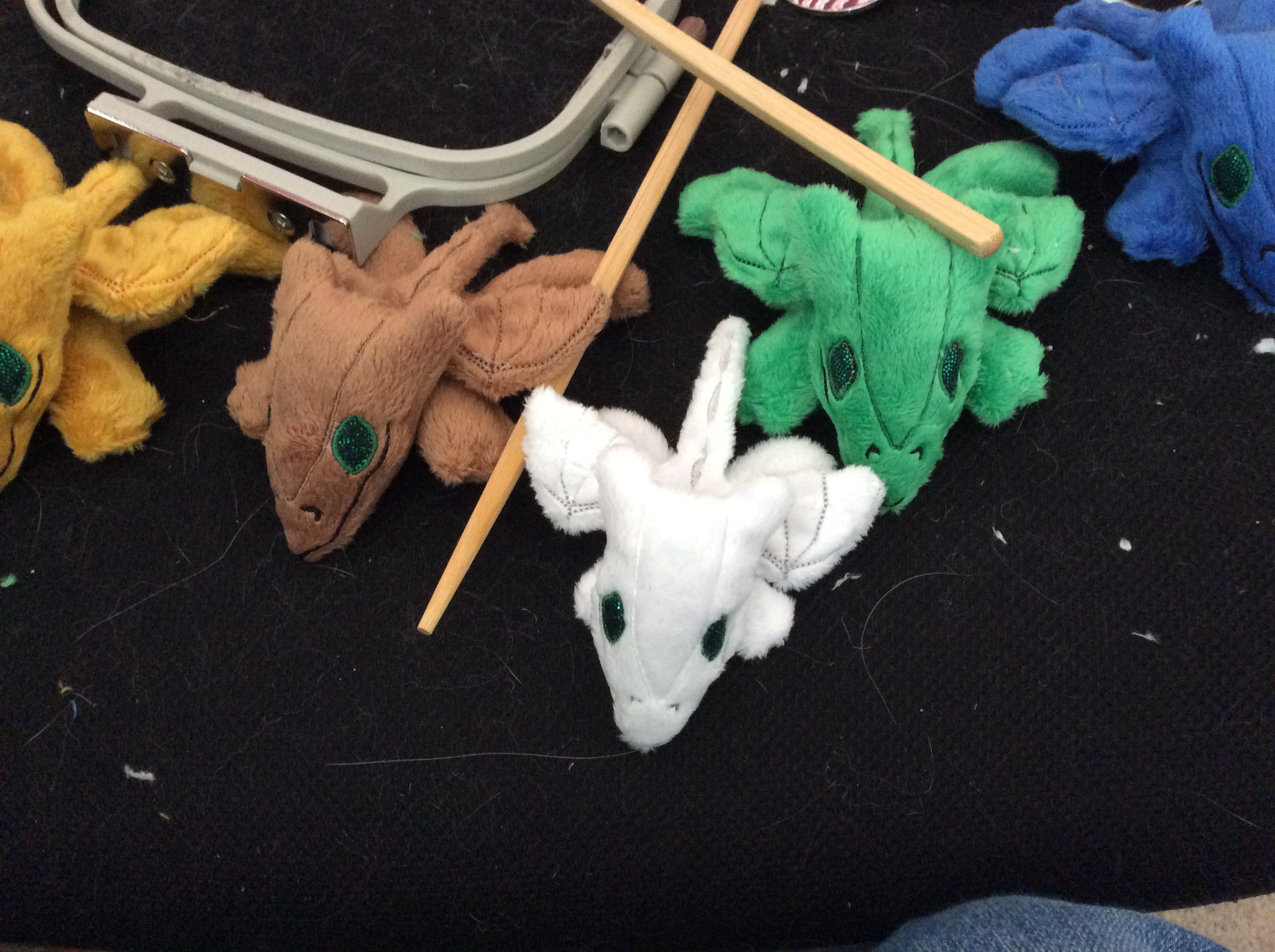 Plush dragons and sewing tools, in progress.
