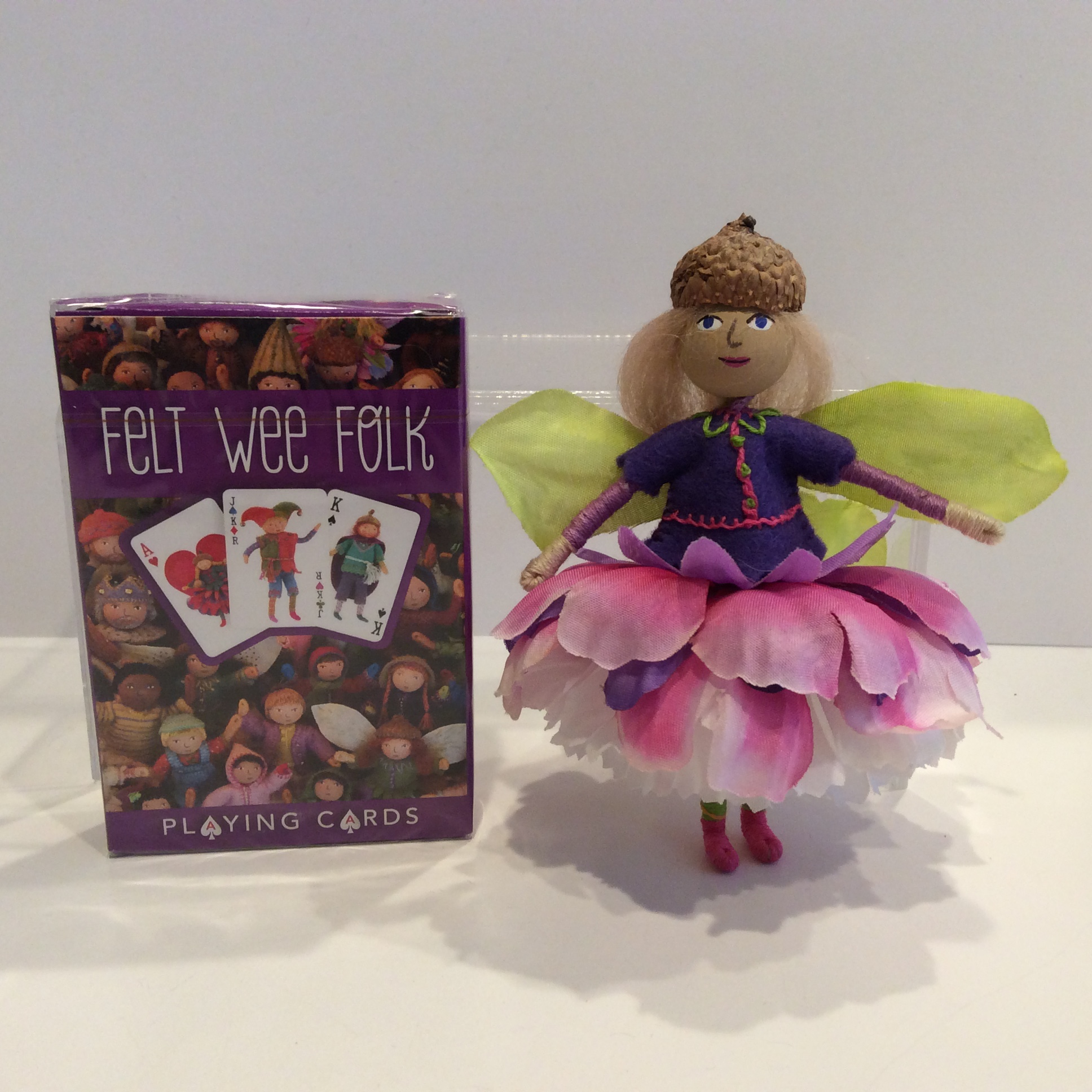 A deck of Felt Wee Folk playing cards next to a Blossom Fairy Doll