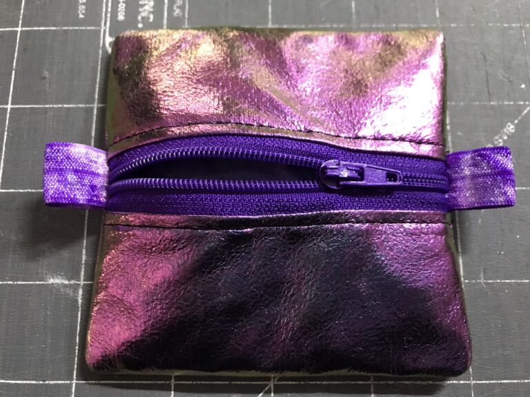 A zippered pouch in iridescent faux leather